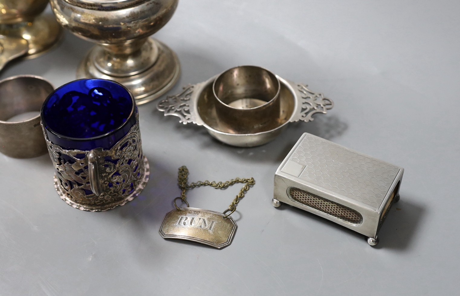 Sundry small silver including two sugar casters, tallest Chester, 1922, 21cm, two mugs, match sleeve, quaich, wine label and three napkin rings